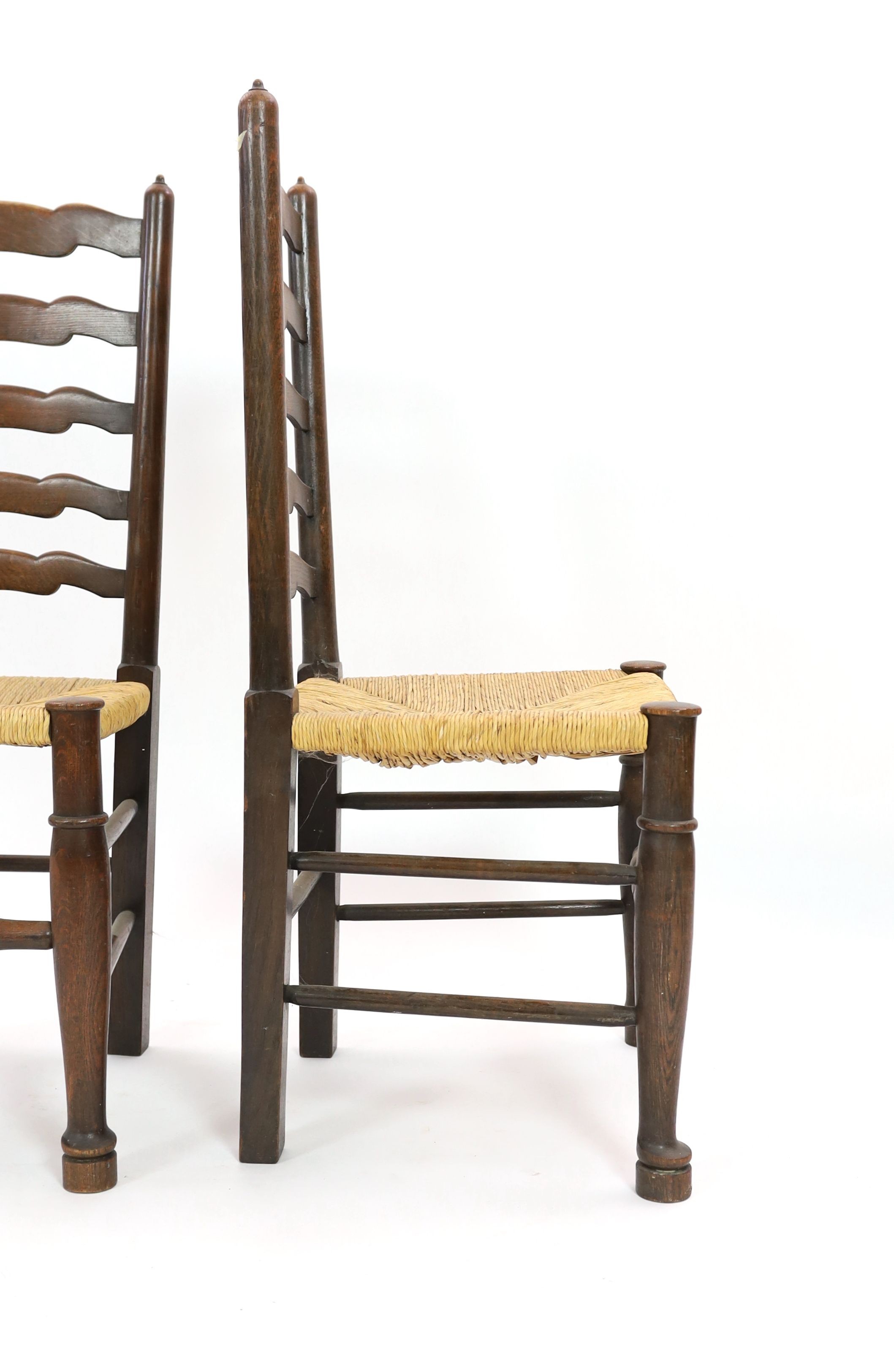 A pair of 18th century style rush seat oak ladderback dining chairs